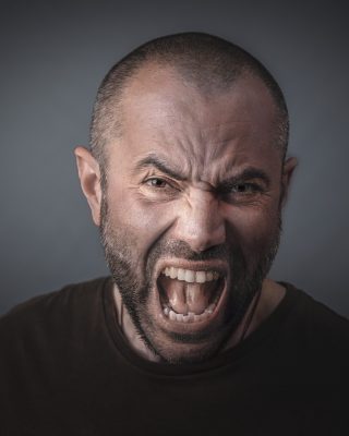 Portrait of angry man screaming. Concept of anger and stress.